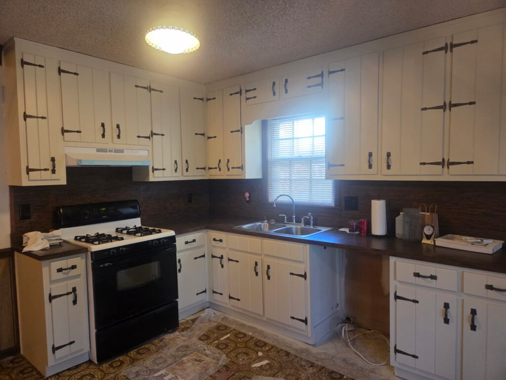 Kitchen cabinets painted white with black hardware