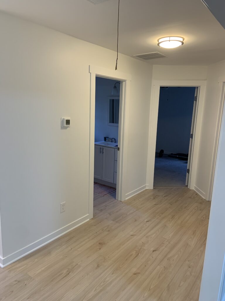 Hallway with light wood-look plank flooring
