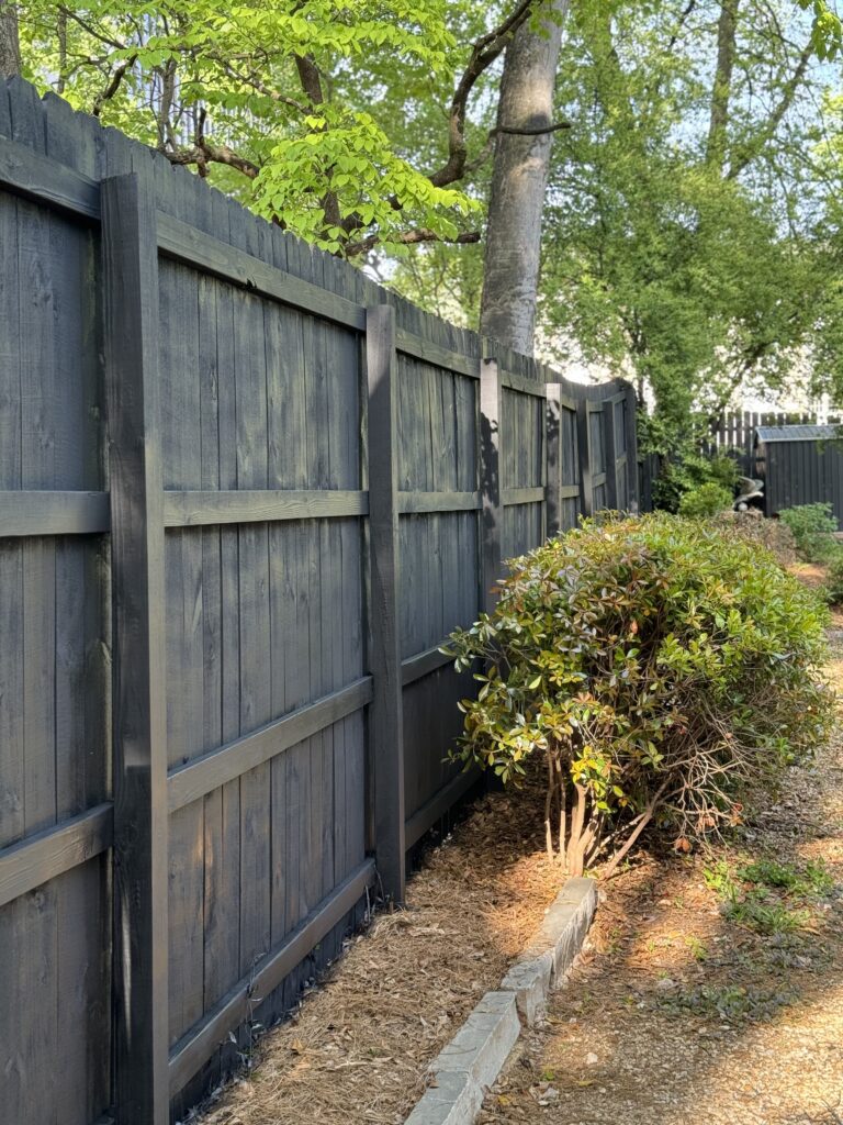 Wood privacy fence with dark stain
