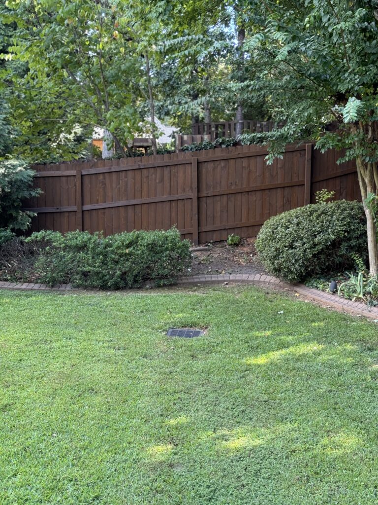 Wood privacy fence with brown stain