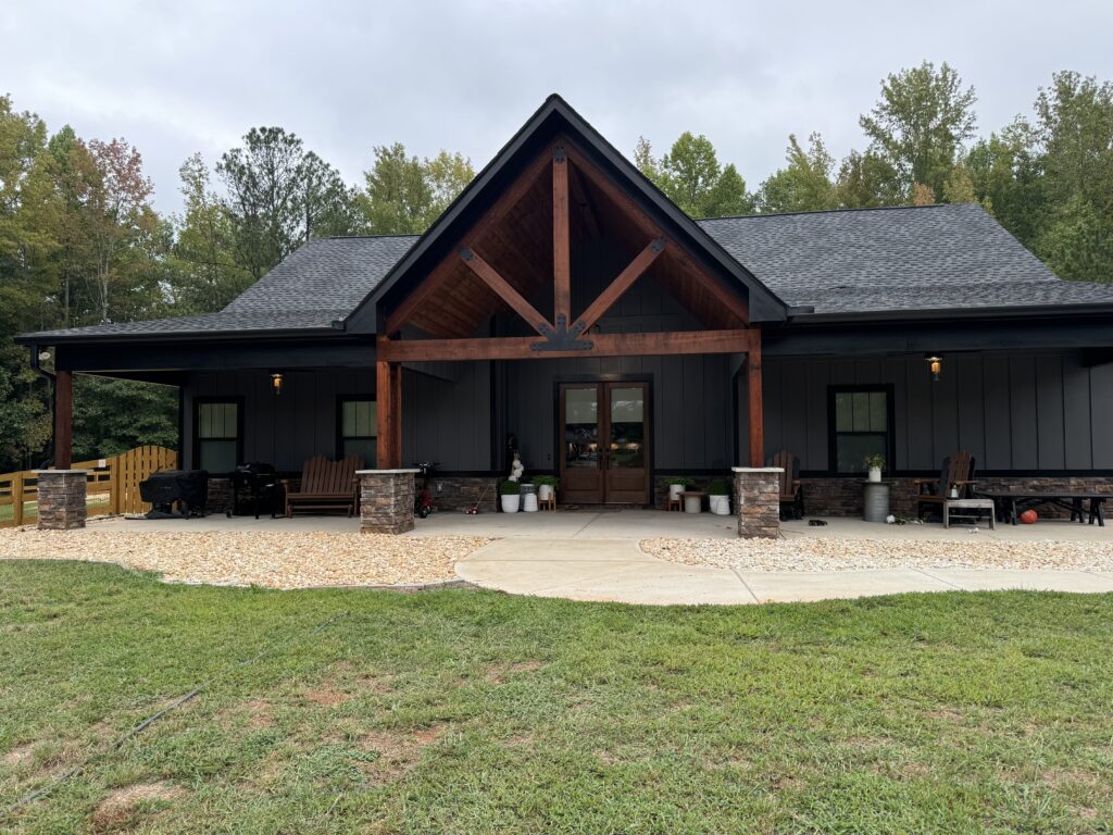 Black farmhouse exterior with cedar gable