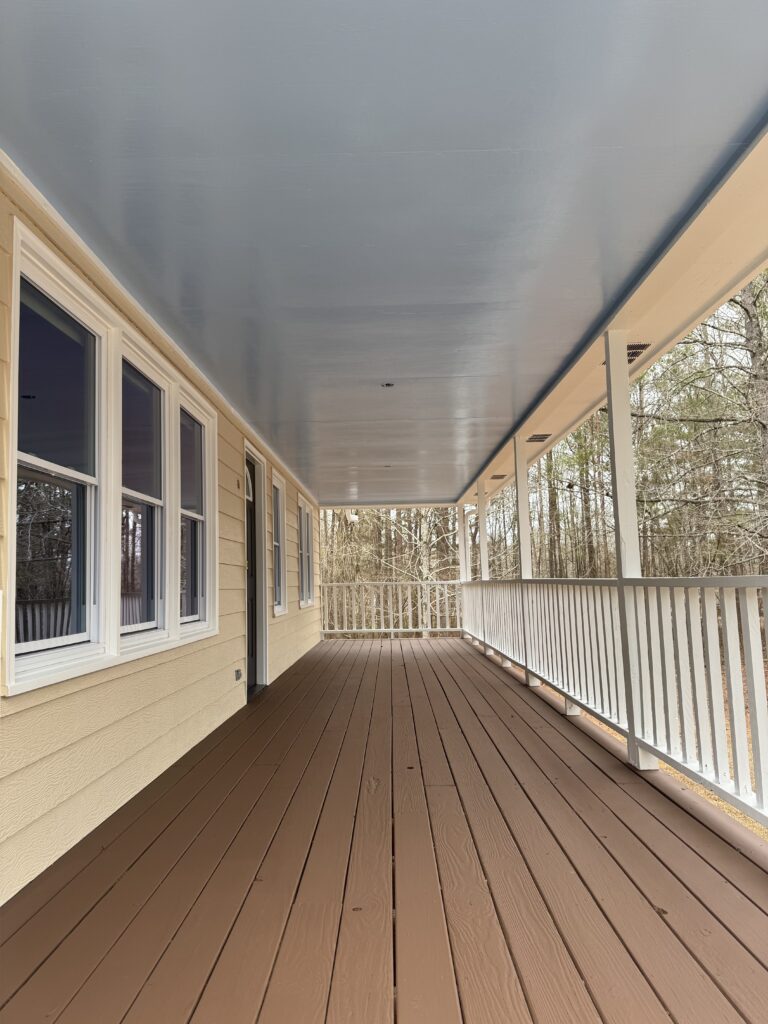 Wraparound porch with stained deck boards