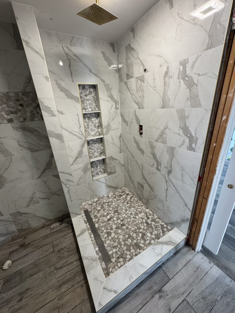 Marble tile shower with built-in niche