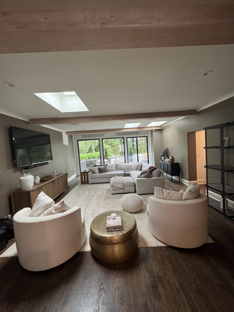 Living room with skylights and hardwood floors
