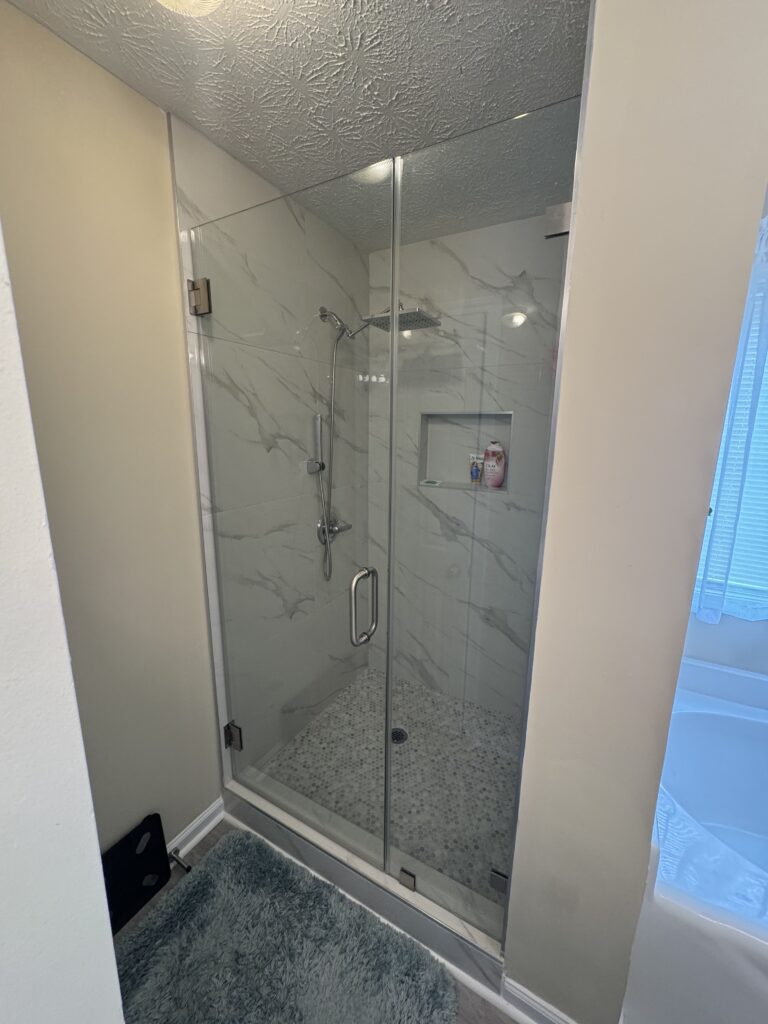 Marble tile shower with glass door