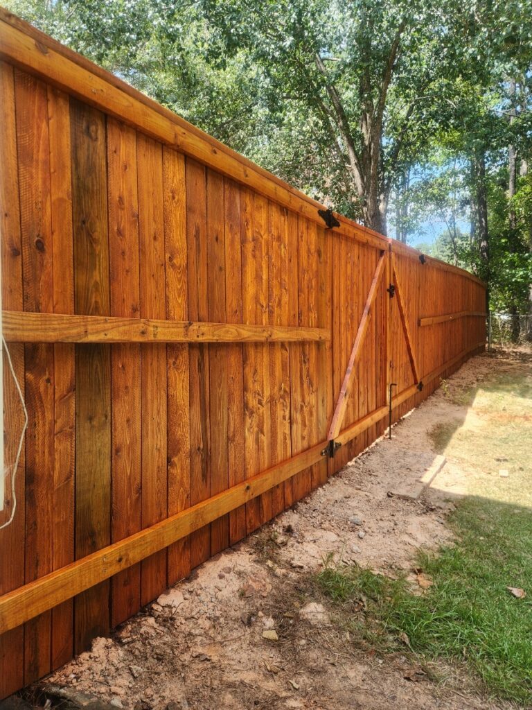 Freshly stained cedar privacy fence
